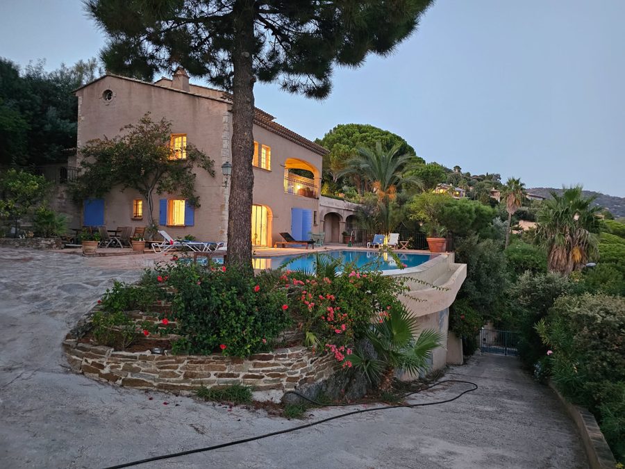 The villa at dusk, pool lit